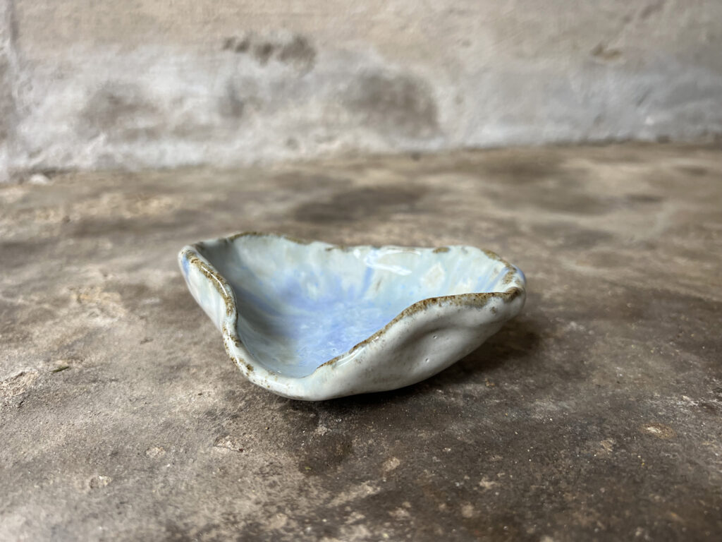 small glossy white and light blue seashell bowl