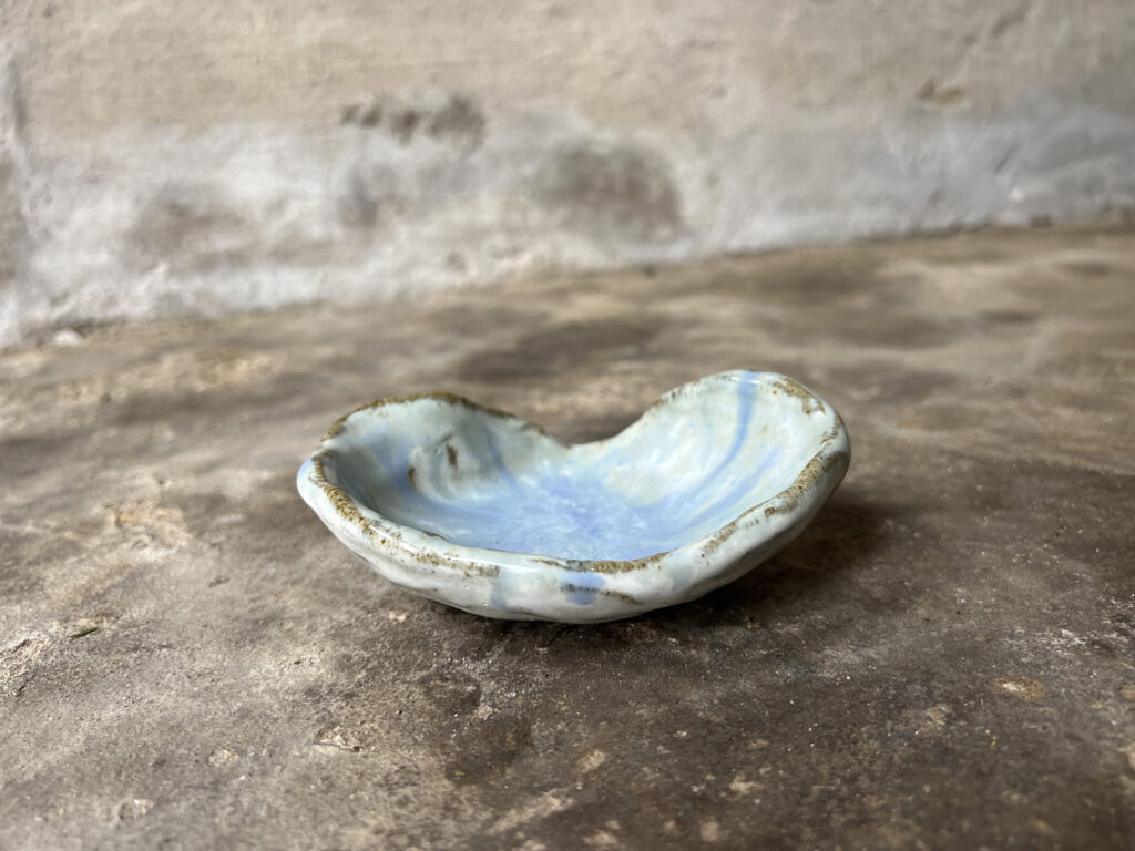 small glossy white and light blue seashell bowl