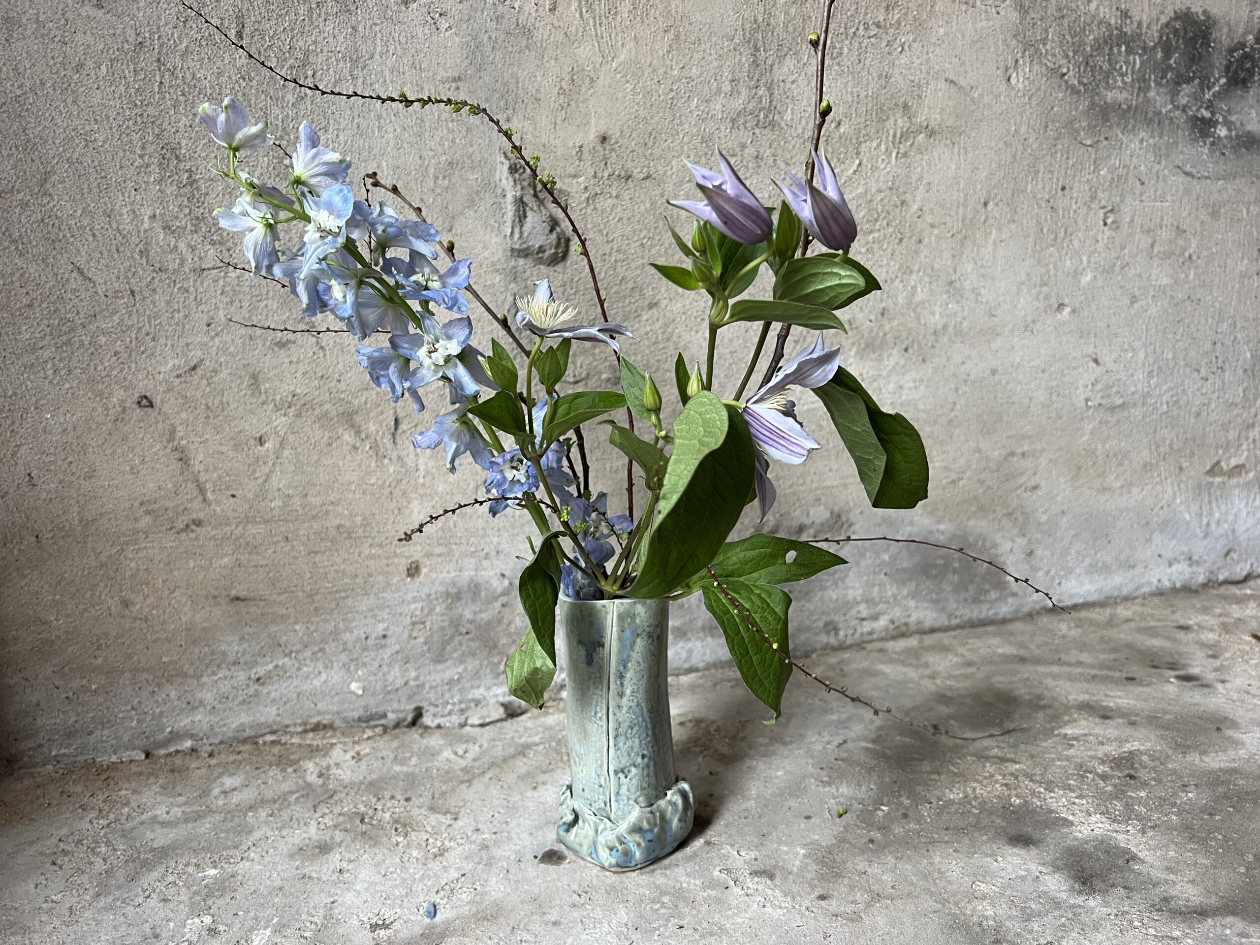 Teal vase with flowers