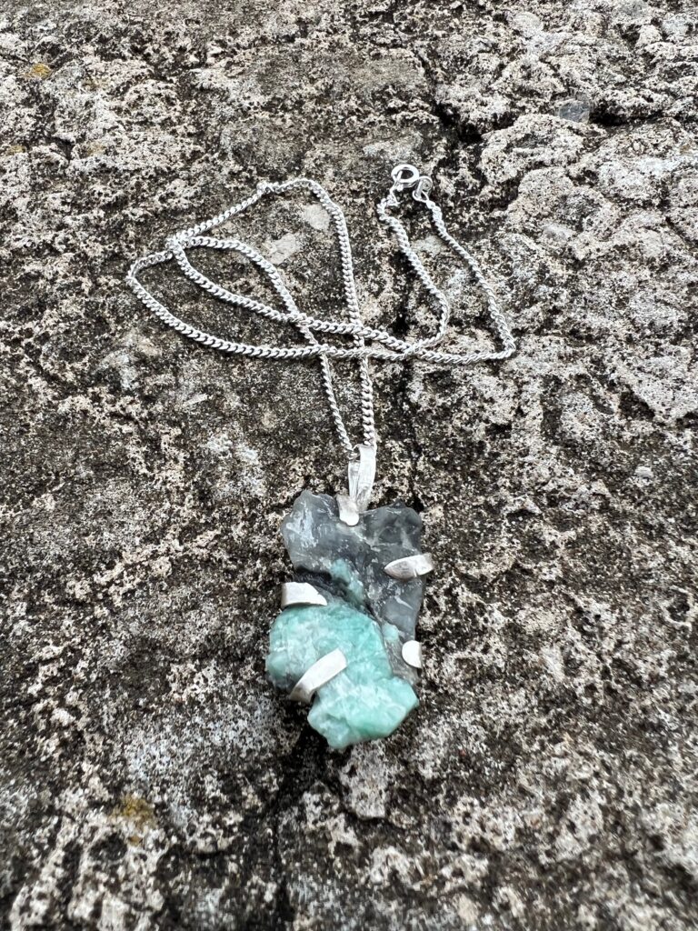 handmade silver necklace with raw emerald crystal